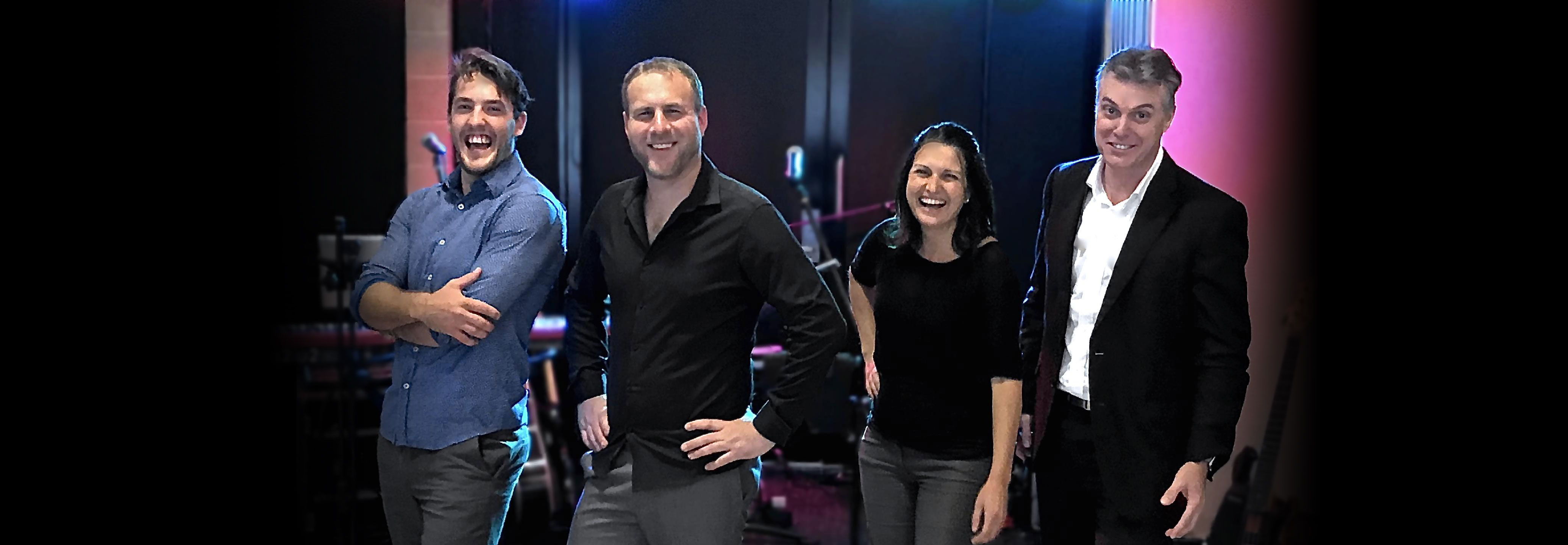 Chris, Jana, Aiden & Josh standing on stage at a function