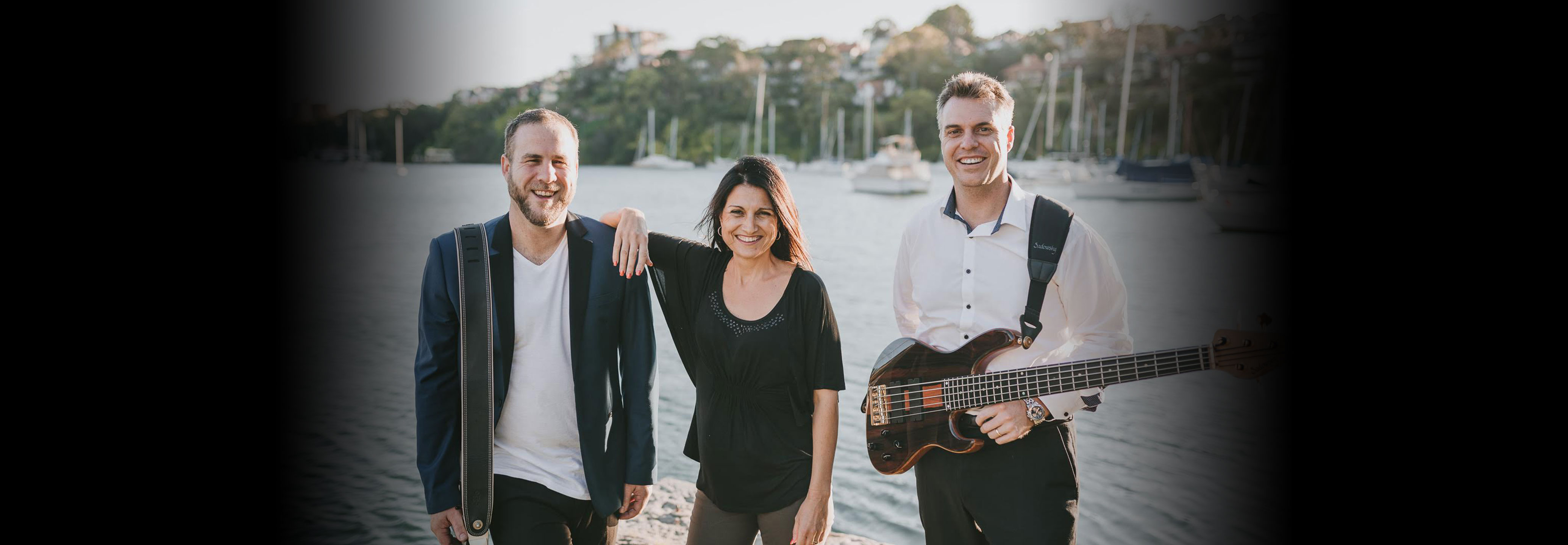 Members of 3 Way Split standing at a marina.